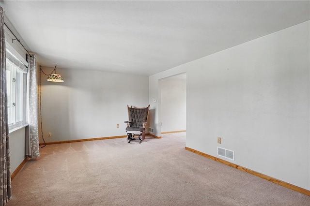 unfurnished room featuring visible vents, carpet flooring, and baseboards