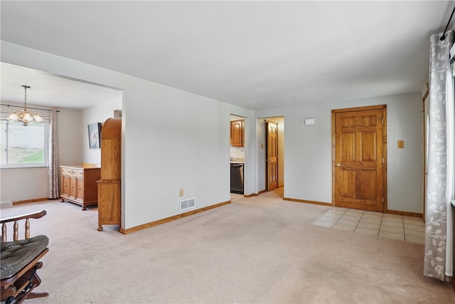 unfurnished living room with light colored carpet, a chandelier, baseboards, light tile patterned floors, and visible vents