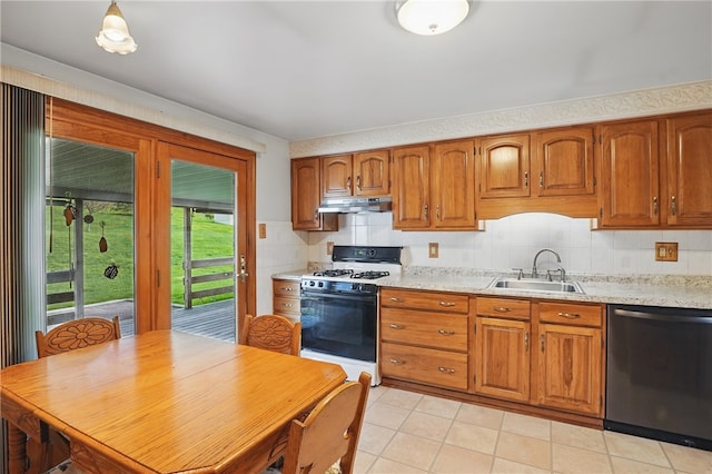 kitchen featuring stainless steel dishwasher, brown cabinetry, gas range, under cabinet range hood, and a sink