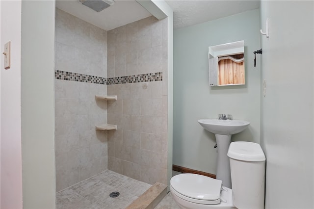 full bath with toilet and tiled shower