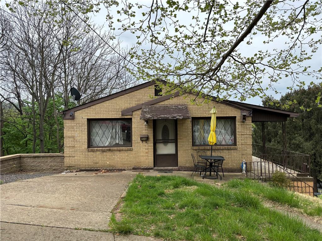 710 College Ave, Oakmont, PA 15139 - bungalow-style home with brick siding and a patio area