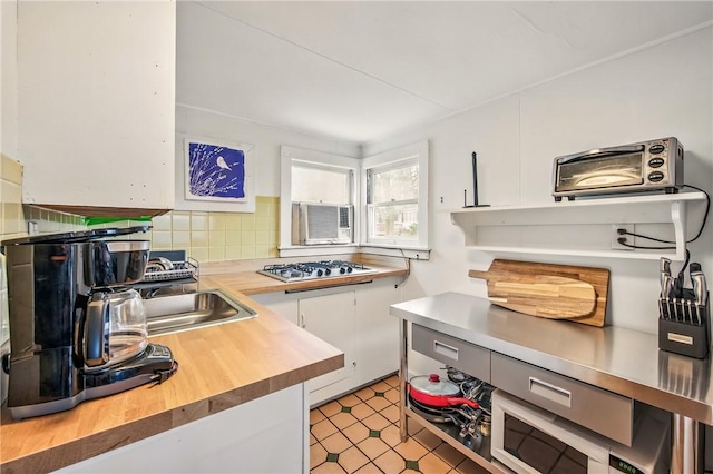 875 Hillside Rd, Jamestown Cra, PA 16134 - kitchen with tasteful backsplash, white cabinetry, a toaster, stainless steel gas stovetop, and butcher block countertops