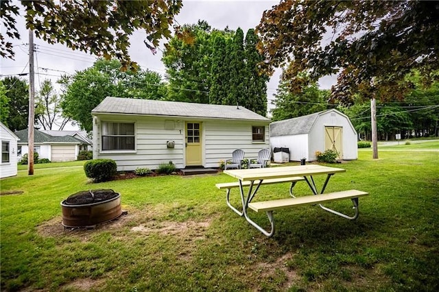 875 Hillside Rd, Jamestown Cra, PA 16134 - back of house featuring a lawn, an outbuilding, a fire pit, and a shed