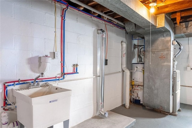utilities featuring heating unit, a sink, and gas water heater