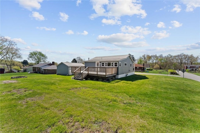 back of house with a yard and a deck