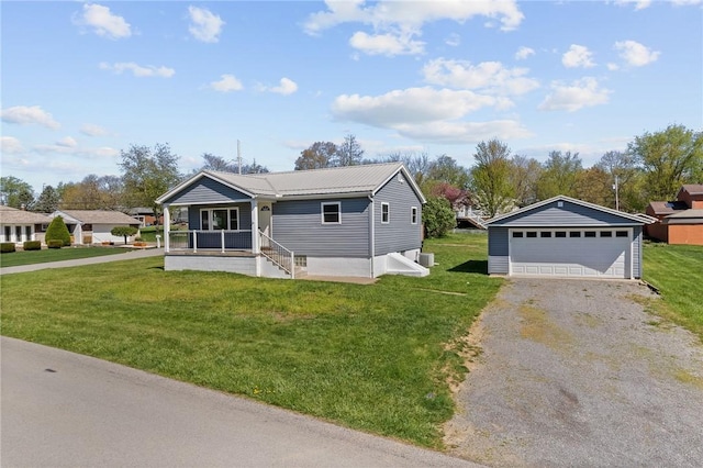 bungalow featuring covered porch, an outdoor structure, a front lawn, and a garage