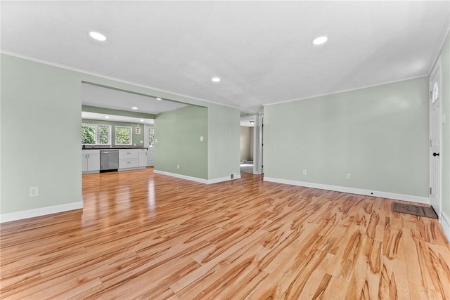 unfurnished living room featuring crown molding, baseboards, recessed lighting, and light wood-style flooring