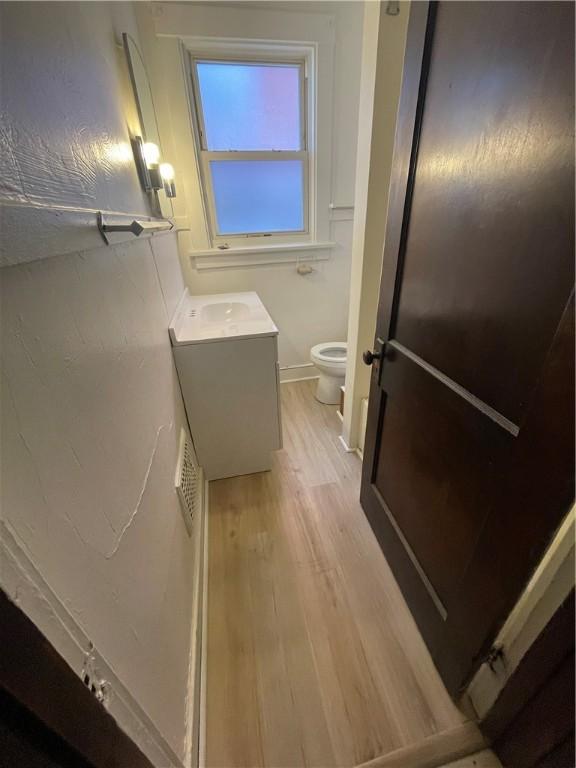 119-121 Giffin Ave, Mount Oliver, PA 15210 - bathroom featuring wood finished floors, toilet, vanity, and baseboards