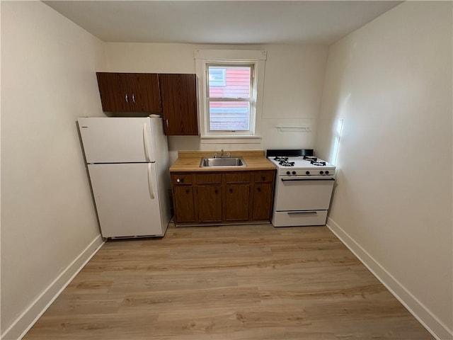 119-121 Giffin Ave, Mount Oliver, PA 15210 - kitchen featuring white appliances, a sink, baseboards, and light wood-style flooring