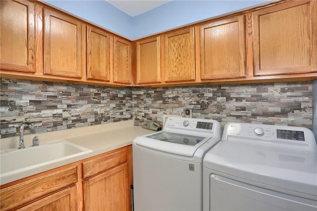 laundry area with a sink, cabinet space, and washing machine and dryer
