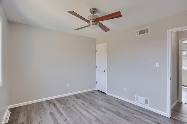 unfurnished bedroom featuring visible vents, baseboards, ceiling fan, and wood finished floors