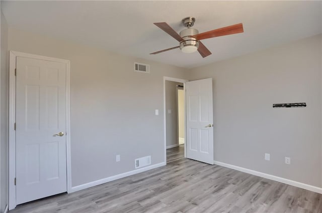 unfurnished bedroom with light wood-type flooring, baseboards, and visible vents