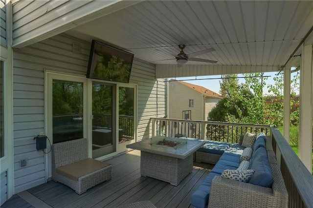 deck with a ceiling fan and an outdoor living space with a fire pit