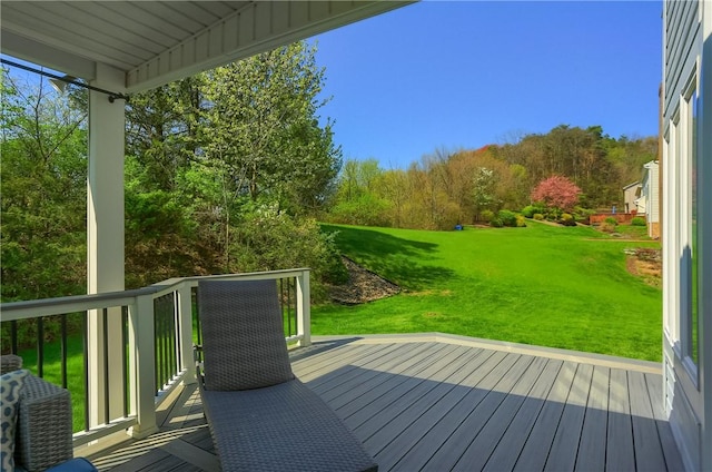 wooden deck featuring a yard