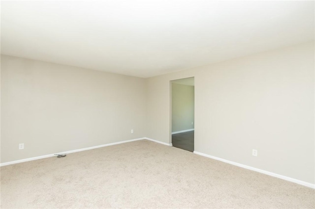 empty room with baseboards and carpet flooring