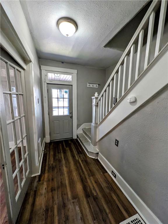 108 Mccandless St, Arnold, PA 15068 - entryway with baseboards, stairs, a textured ceiling, and wood finished floors