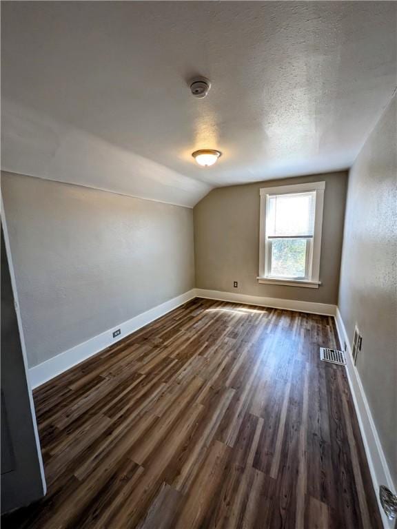 108 Mccandless St, Arnold, PA 15068 - additional living space with dark wood-style flooring, baseboards, visible vents, and lofted ceiling