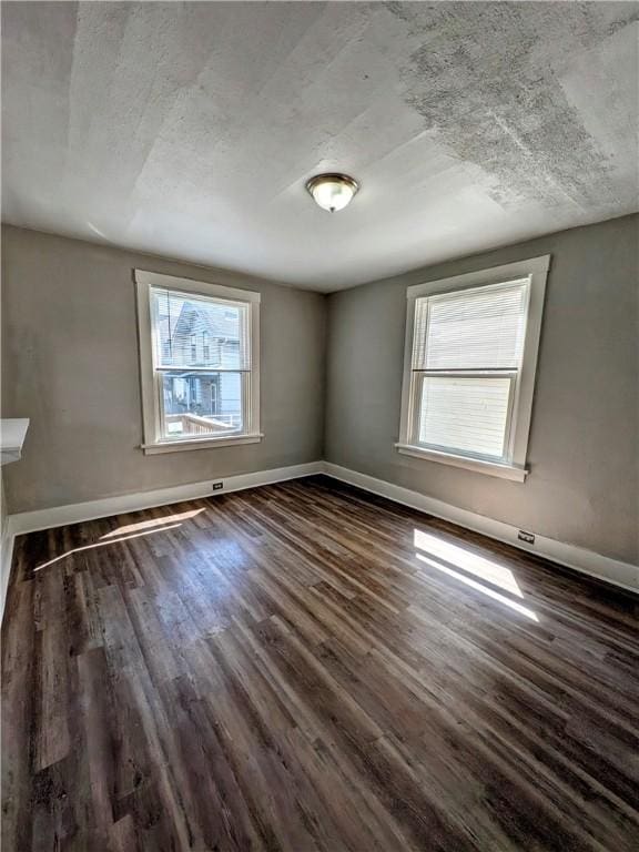 108 Mccandless St, Arnold, PA 15068 - spare room with baseboards and dark wood-type flooring