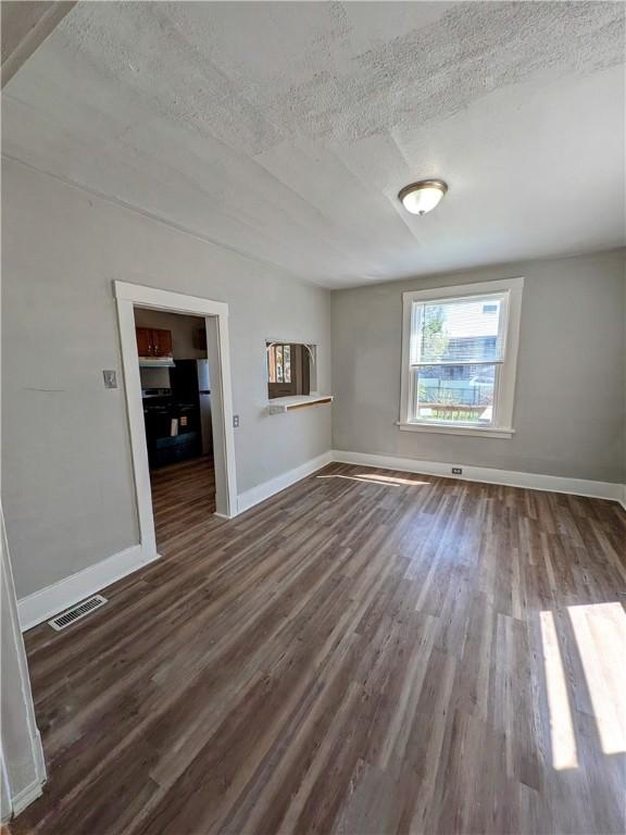 108 Mccandless St, Arnold, PA 15068 - empty room featuring dark wood-style flooring, baseboards, visible vents, and a textured ceiling