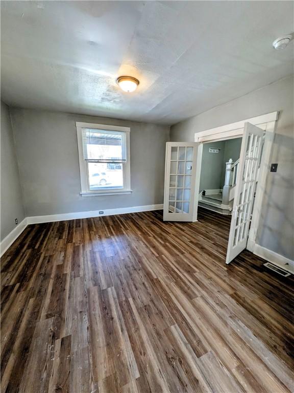 108 Mccandless St, Arnold, PA 15068 - spare room featuring baseboards, french doors, and wood finished floors