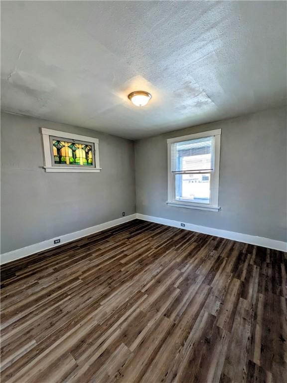 108 Mccandless St, Arnold, PA 15068 - spare room with baseboards, dark wood-style floors, and a textured ceiling