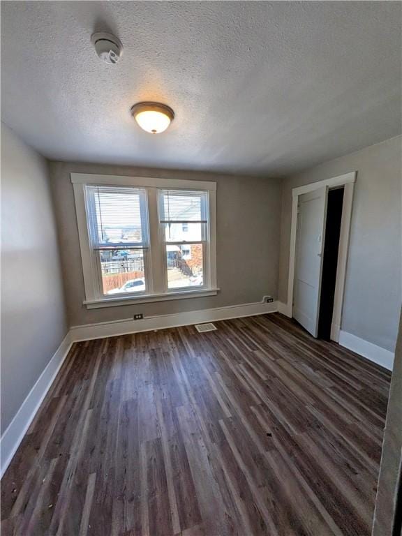 108 Mccandless St, Arnold, PA 15068 - unfurnished bedroom featuring dark wood-style flooring, a textured ceiling, visible vents, and baseboards
