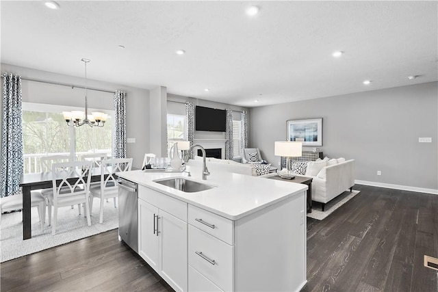 kitchen featuring a sink, an inviting chandelier, dark wood finished floors, and white cabinetry