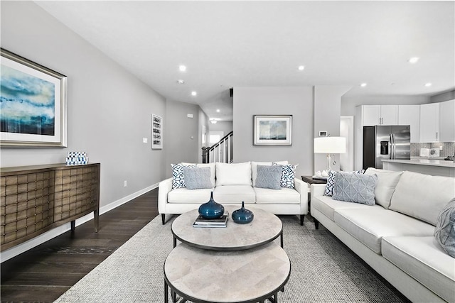 living room featuring stairs, dark wood-style flooring, baseboards, and recessed lighting
