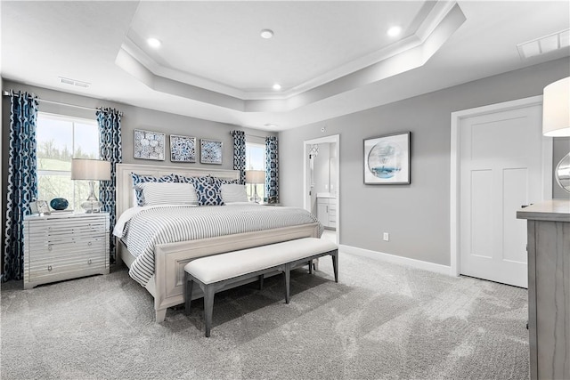bedroom featuring carpet floors, multiple windows, baseboards, and a raised ceiling
