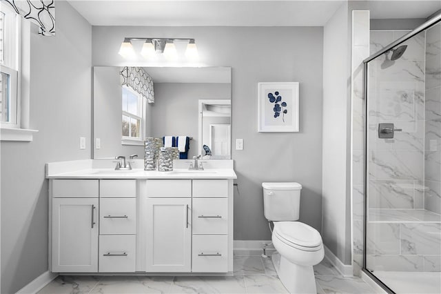 bathroom with a sink, toilet, marble finish floor, baseboards, and a shower stall