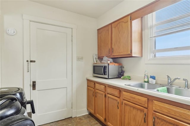 715-717 Hiland Ave, Coraopolis, PA 15108 - kitchen featuring light countertops, brown cabinets, stainless steel microwave, and a sink
