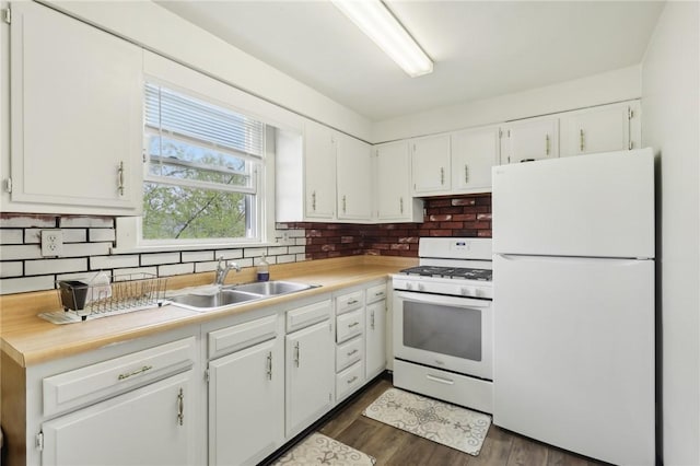 715-717 Hiland Ave, Coraopolis, PA 15108 - kitchen featuring a sink, white cabinetry, white appliances, and tasteful backsplash