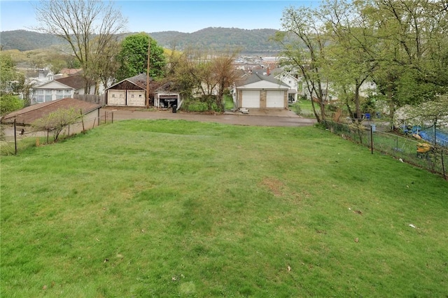 715-717 Hiland Ave, Coraopolis, PA 15108 - view of yard with fence, a detached garage, and a mountain view