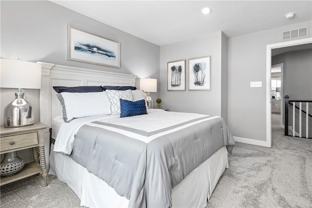 carpeted bedroom with baseboards and visible vents