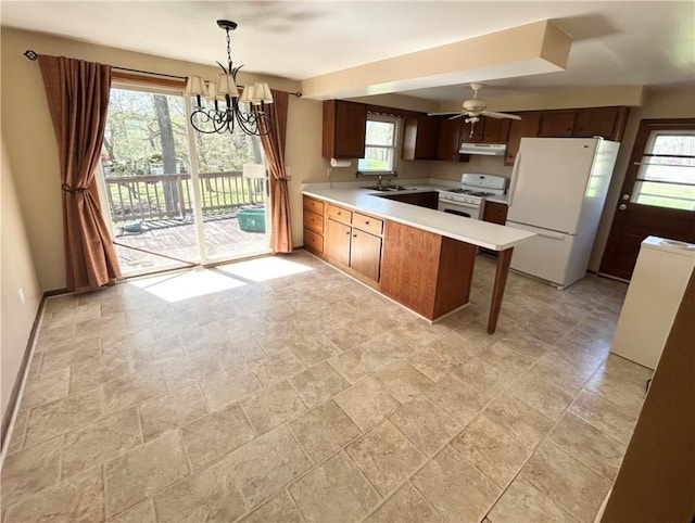 2144 Highland Dr, Summit Twp But, PA 16002 - kitchen featuring a sink, white appliances, a peninsula, stone finish flooring, and under cabinet range hood