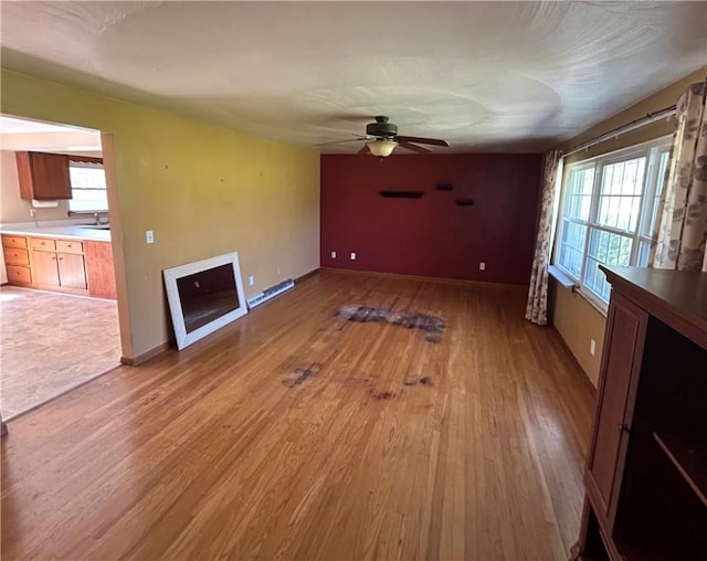 2144 Highland Dr, Summit Twp But, PA 16002 - unfurnished living room with plenty of natural light, a ceiling fan, and light wood-style flooring