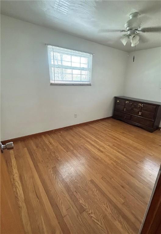 2144 Highland Dr, Summit Twp But, PA 16002 - spare room with baseboards, ceiling fan, and wood finished floors