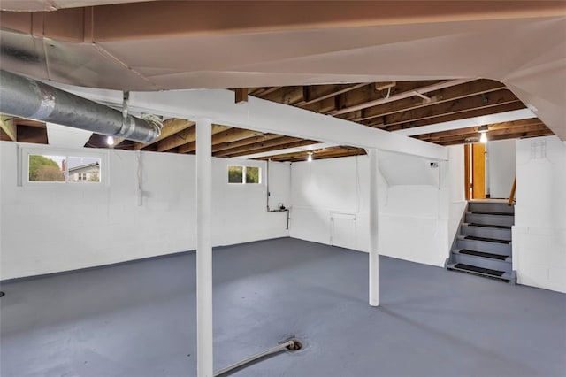 basement with a wealth of natural light and stairway