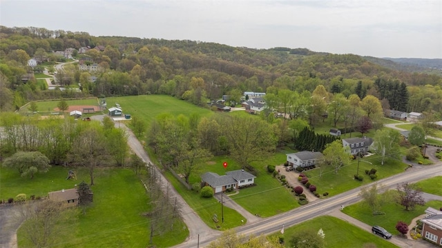drone / aerial view featuring a wooded view