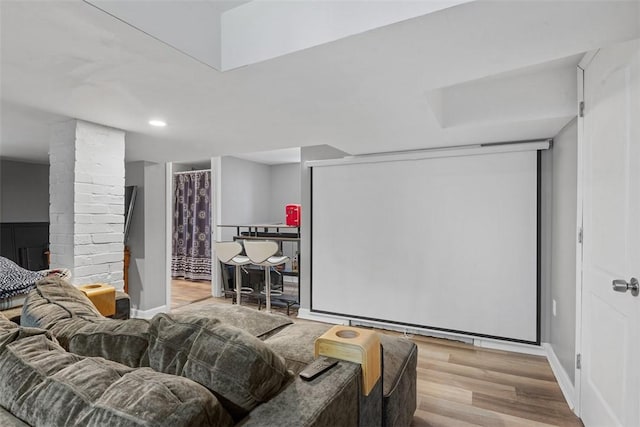 home theater room with baseboards, decorative columns, recessed lighting, and wood finished floors