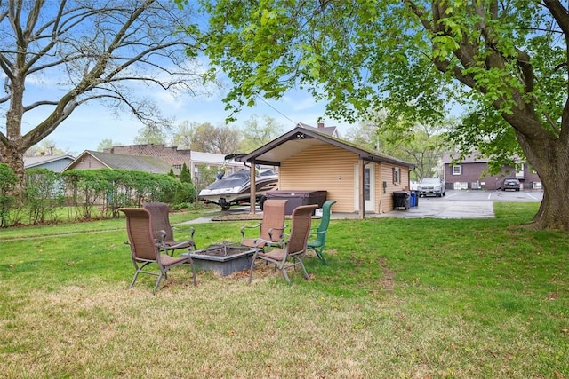 view of yard featuring a hot tub and an outdoor fire pit