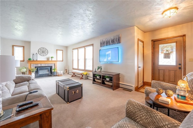 living room with baseboard heating, carpet floors, baseboards, and a fireplace