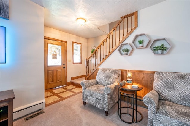 entrance foyer with visible vents, baseboards, a baseboard radiator, a baseboard heating unit, and stairway