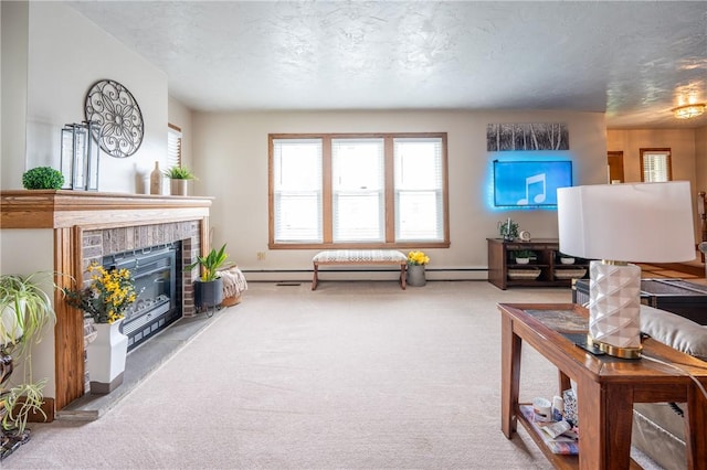 carpeted living room with baseboards, baseboard heating, a brick fireplace, and a textured ceiling