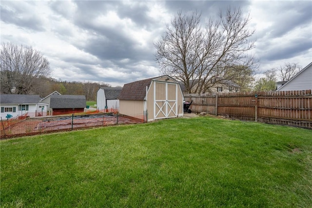 view of yard with a shed, an outbuilding, and fence