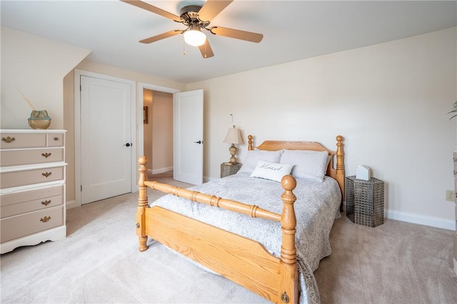 bedroom featuring baseboards, ceiling fan, and light carpet