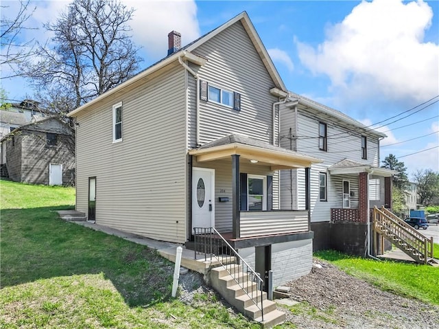 204 N 4th St, Jeannette, PA 15644 - view of front of house with a chimney and a front lawn