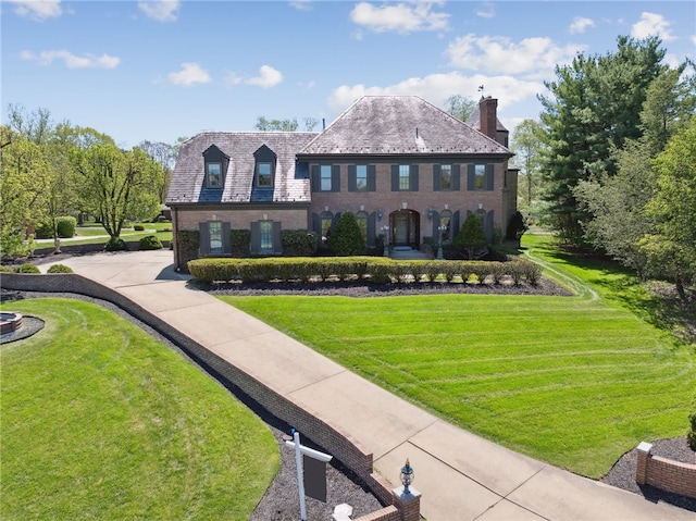 107 Treetop Ln, Peters Twp, PA 15317 - georgian-style home with brick siding, a chimney, a high end roof, and a front yard