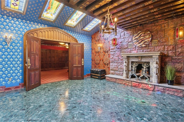 107 Treetop Ln, Peters Twp, PA 15317 - unfurnished living room featuring an inviting chandelier, baseboards, a fireplace, and wallpapered walls