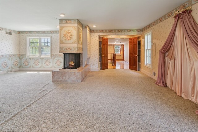 107 Treetop Ln, Peters Twp, PA 15317 - unfurnished living room featuring a multi sided fireplace, carpet flooring, and wallpapered walls